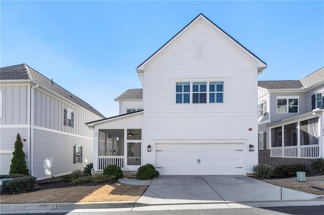 traditional home with covered porch, driveway, an attached garage, and ceiling fan