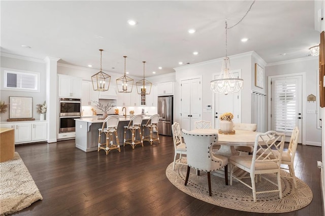 dining space with a chandelier, ornamental molding, dark wood finished floors, and recessed lighting