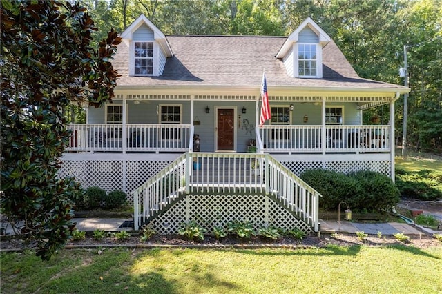 cape cod-style house with covered porch and a front yard