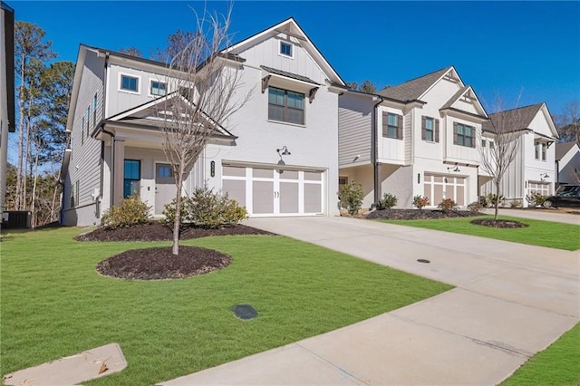 view of front of property featuring central air condition unit, a front lawn, and a garage