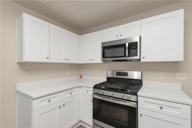 kitchen featuring white cabinetry and appliances with stainless steel finishes