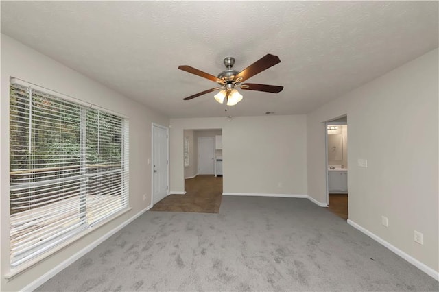 unfurnished room with ceiling fan and light colored carpet