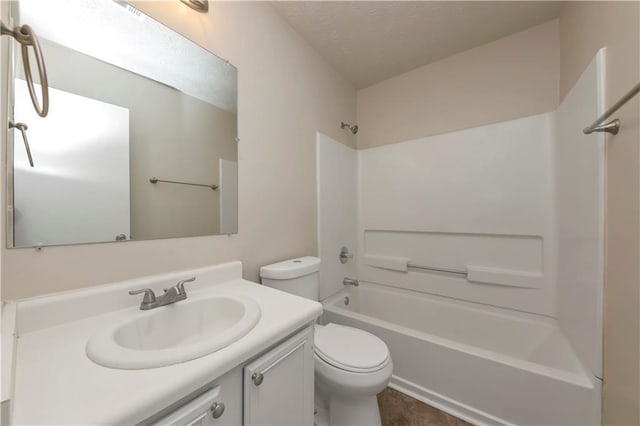 full bathroom with shower / bathing tub combination, vanity, a textured ceiling, and toilet