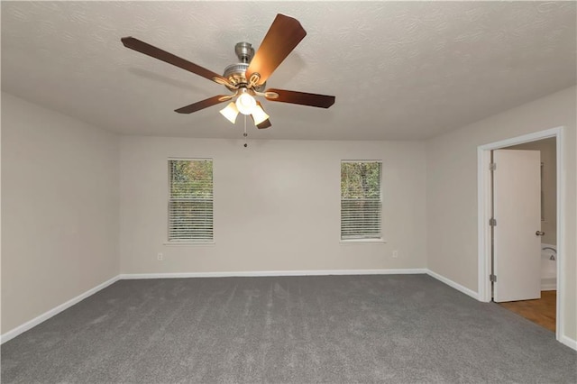 carpeted empty room featuring ceiling fan, a healthy amount of sunlight, and a textured ceiling