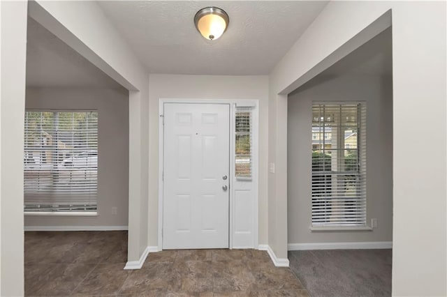 entryway with a textured ceiling