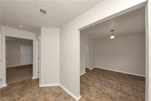 spare room featuring a textured ceiling