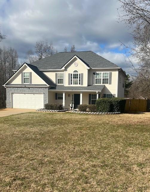 view of front property with a garage and a front yard