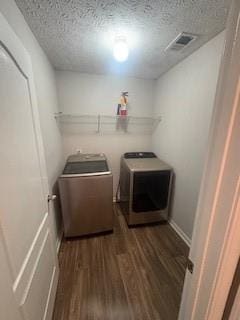 215 Bradley St, Covington, GA 30016 - laundry area featuring a textured ceiling, washing machine and clothes dryer, and dark hardwood / wood-style flooring