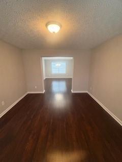 215 Bradley St, Covington, GA 30016 - empty room featuring dark hardwood / wood-style floors and a textured ceiling