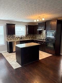 215 Bradley St, Covington, GA 30016 - kitchen featuring tasteful backsplash, light hardwood / wood-style floors, oven, and a center island