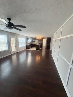 215 Bradley St, Covington, GA 30016 - unfurnished living room featuring ceiling fan, dark hardwood / wood-style floors, and a textured ceiling