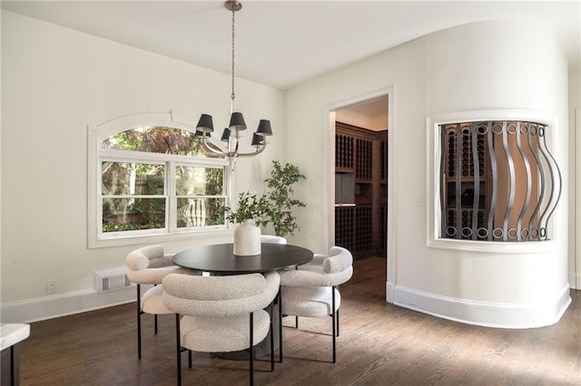 dining room featuring an inviting chandelier and dark hardwood / wood-style floors