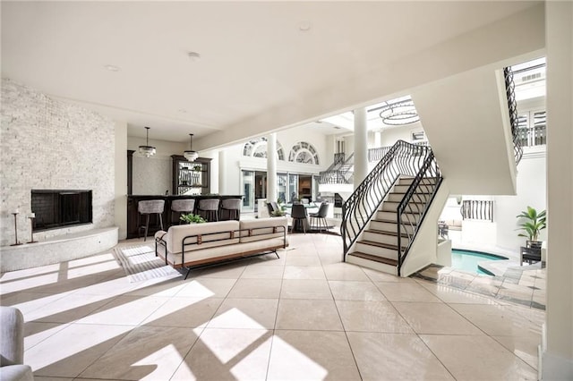 living room featuring a fireplace and light tile patterned floors