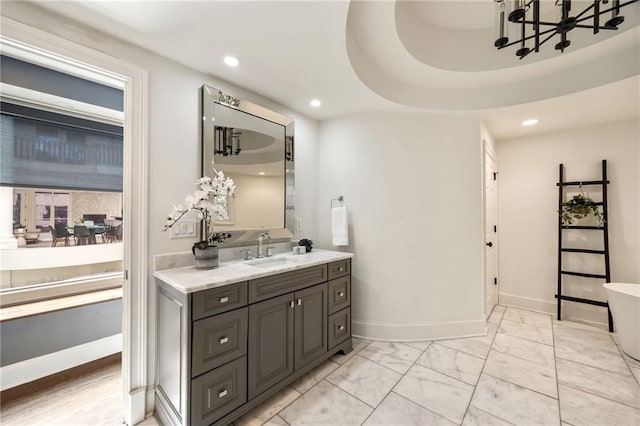 bathroom with vanity and an inviting chandelier