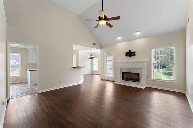 16 Kentucky Walk NE, Cartersville, GA 30121 - unfurnished living room featuring high vaulted ceiling, a high end fireplace, a chandelier, ceiling fan, and dark wood-style floors