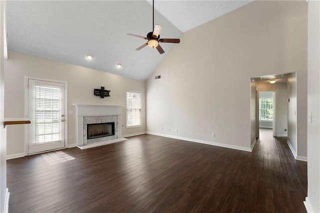 16 Kentucky Walk NE, Cartersville, GA 30121 - unfurnished living room featuring ceiling fan, high vaulted ceiling, dark wood-type flooring, a high end fireplace, and baseboards
