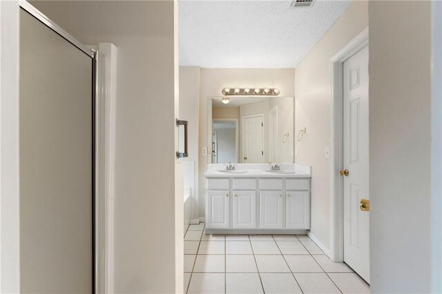 16 Kentucky Walk NE, Cartersville, GA 30121 - full bath with tile patterned flooring, double vanity, baseboards, an enclosed shower, and a textured ceiling