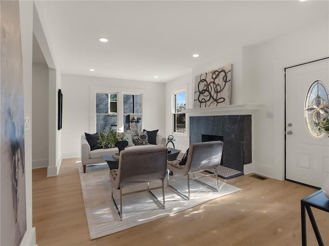 living room with a fireplace and light hardwood / wood-style floors