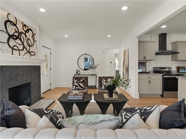 living room with light hardwood / wood-style floors and a fireplace