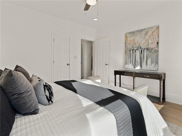 bedroom featuring hardwood / wood-style floors and ceiling fan