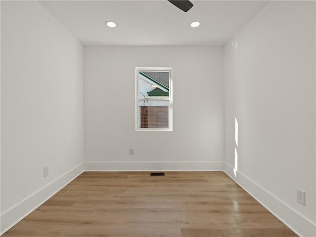 empty room with light hardwood / wood-style flooring