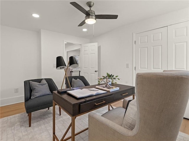 office space with light wood-type flooring and ceiling fan