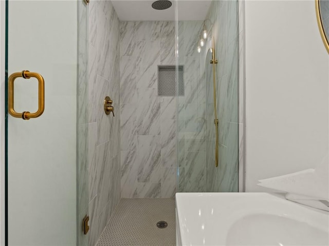 bathroom featuring a shower with shower door