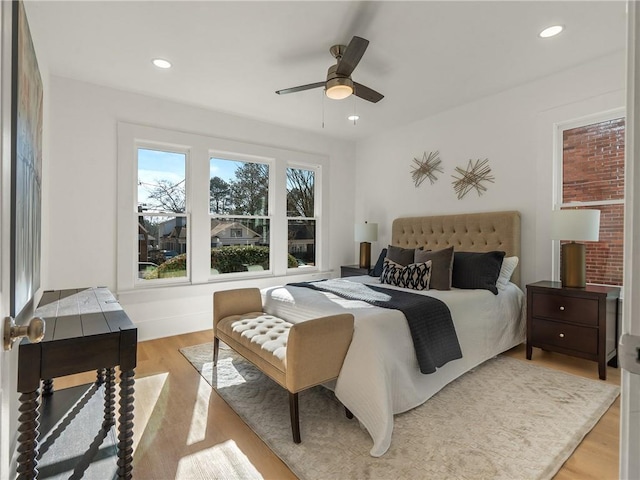 bedroom with light hardwood / wood-style flooring and ceiling fan