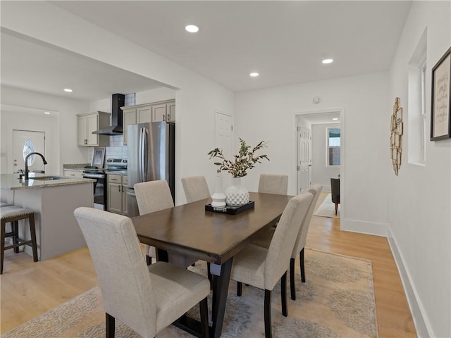 dining room featuring light hardwood / wood-style flooring and sink