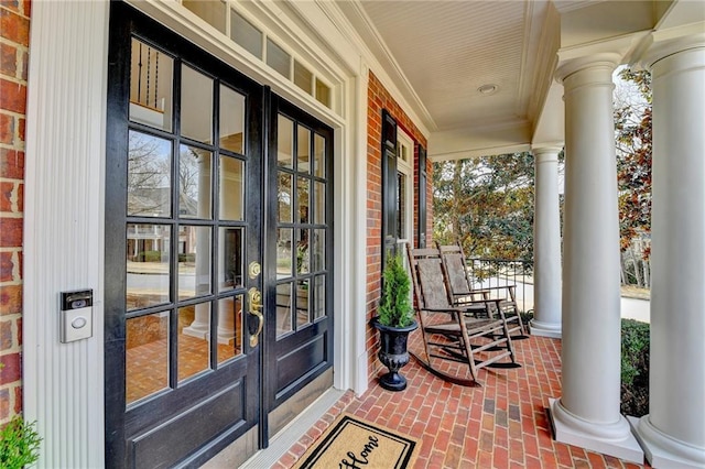 entrance to property featuring brick siding