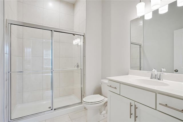 full bath featuring a stall shower, tile patterned flooring, vanity, and toilet