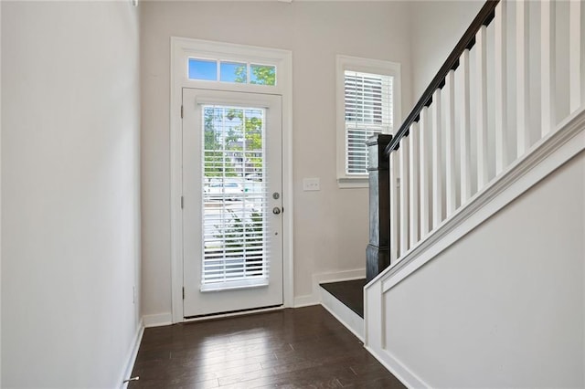 foyer entrance with stairs, baseboards, and hardwood / wood-style floors