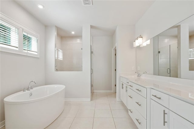 full bathroom featuring visible vents, tile patterned floors, a freestanding bath, vanity, and a shower stall