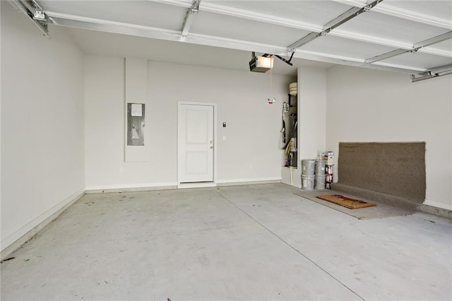 garage featuring electric panel and baseboards