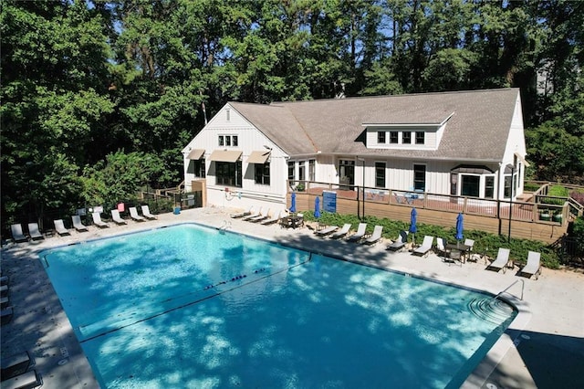 community pool featuring a patio and fence