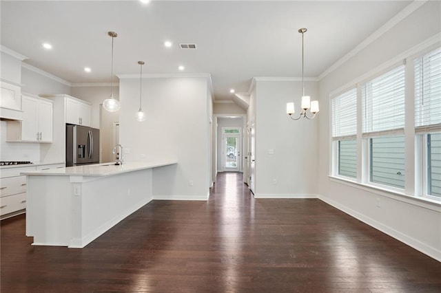 kitchen featuring dark wood finished floors, stainless steel fridge with ice dispenser, light countertops, white cabinets, and baseboards