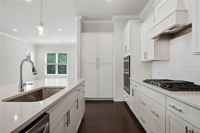 kitchen featuring custom exhaust hood, stainless steel appliances, white cabinets, a sink, and light stone countertops