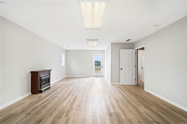 2279 Jerusalem Church Rd, Jasper, GA 30143 - unfurnished living room featuring light hardwood / wood-style flooring and a textured ceiling