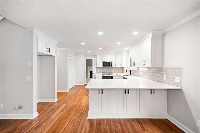 2279 Jerusalem Church Rd, Jasper, GA 30143 - kitchen with white cabinets, stainless steel appliances, backsplash, and kitchen peninsula