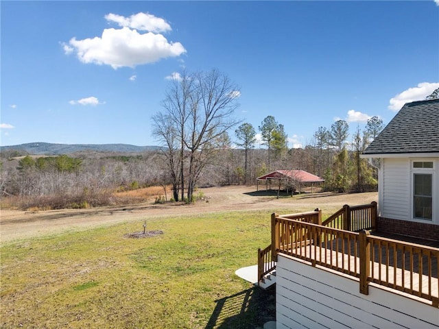 view of yard with a deck and a carport