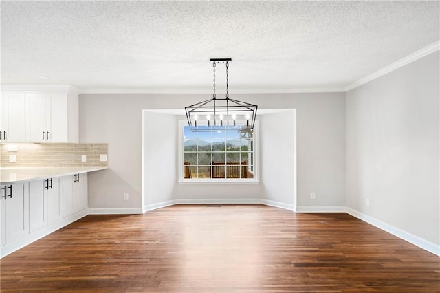 2279 Jerusalem Church Rd, Jasper, GA 30143 - unfurnished dining area with a textured ceiling, dark wood-type flooring, a chandelier, and ornamental molding