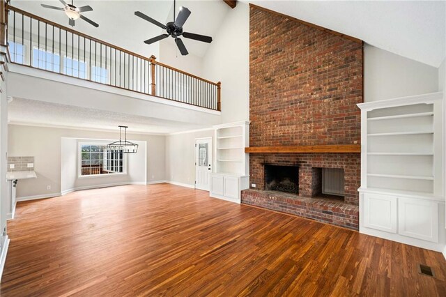 2279 Jerusalem Church Rd, Jasper, GA 30143 - unfurnished living room featuring hardwood / wood-style floors, built in shelves, ceiling fan, a fireplace, and high vaulted ceiling