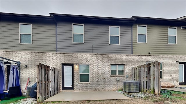 back of property featuring a patio and central air condition unit