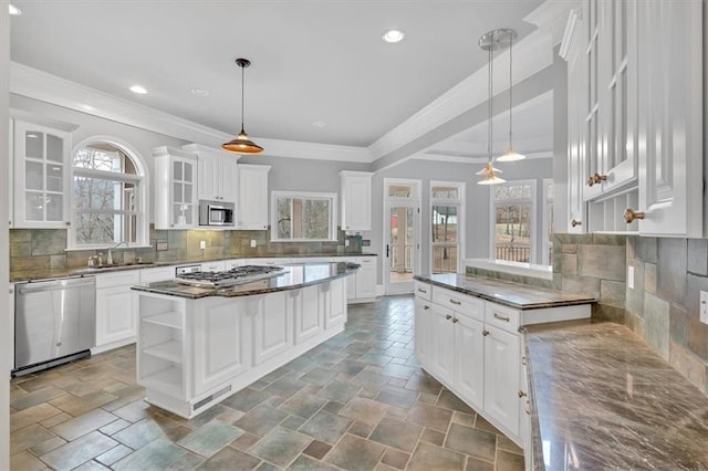 kitchen featuring a sink, white cabinets, stainless steel appliances, and open shelves