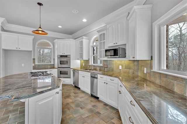 kitchen with a sink, stainless steel appliances, and white cabinets