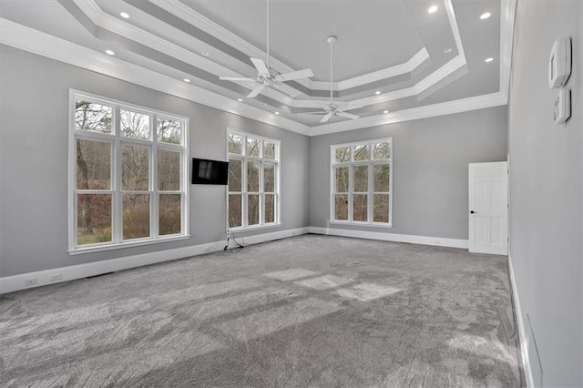 carpeted empty room featuring baseboards, crown molding, and a tray ceiling