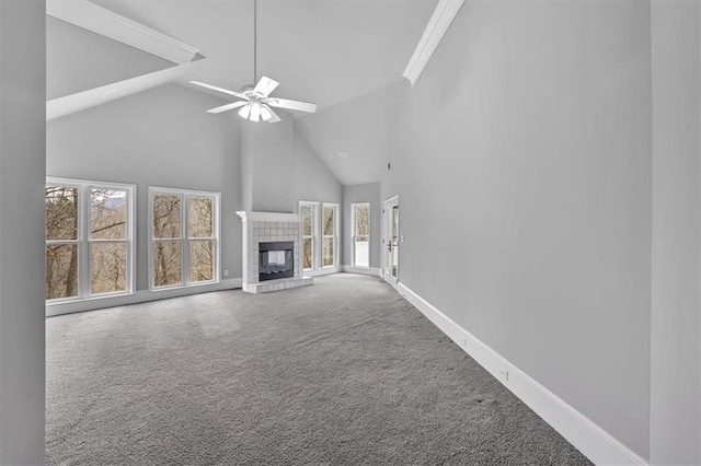 unfurnished living room featuring a ceiling fan, baseboards, carpet floors, high vaulted ceiling, and a tile fireplace