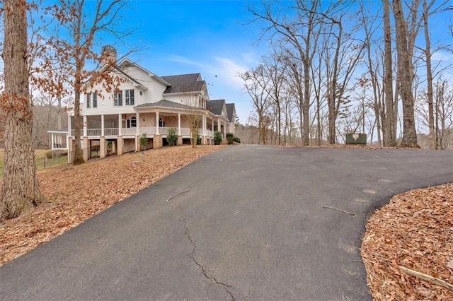 exterior space featuring a porch and driveway