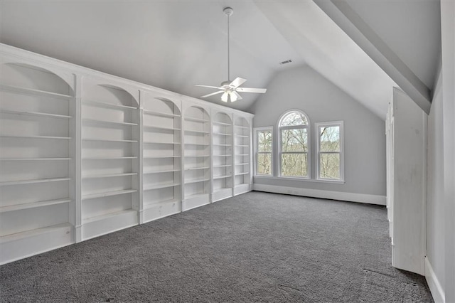 carpeted empty room featuring built in shelves, a ceiling fan, and lofted ceiling