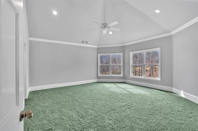 carpeted spare room with visible vents, crown molding, baseboards, ceiling fan, and vaulted ceiling